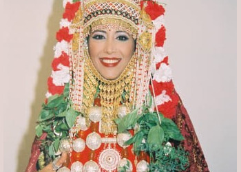 Ofra Haza in elaborate traditional costume with floral headdress